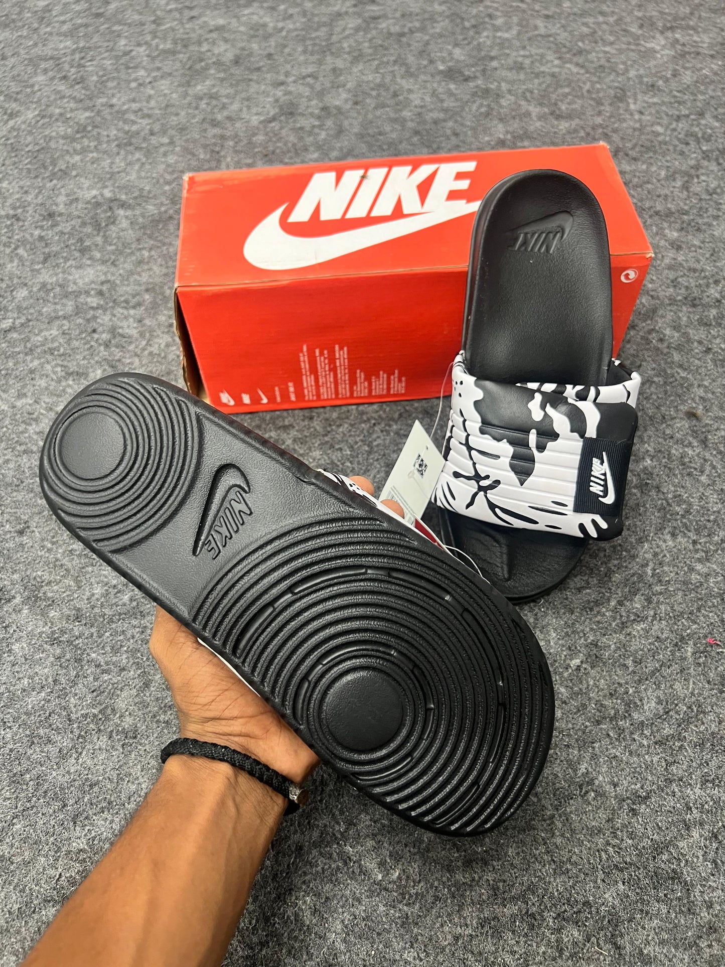 Nike slides with a black & white strap