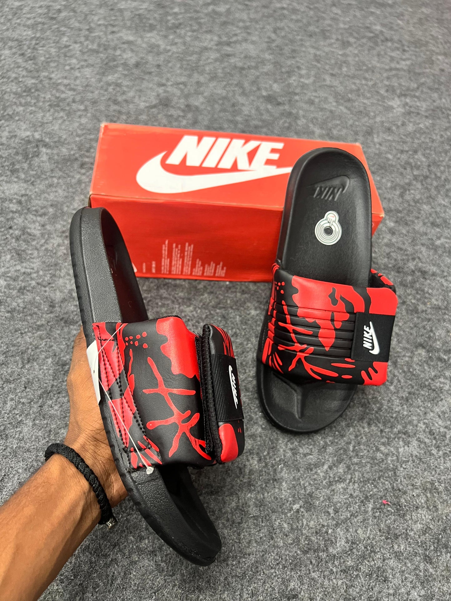 Bold Nike slides with a red and black strap