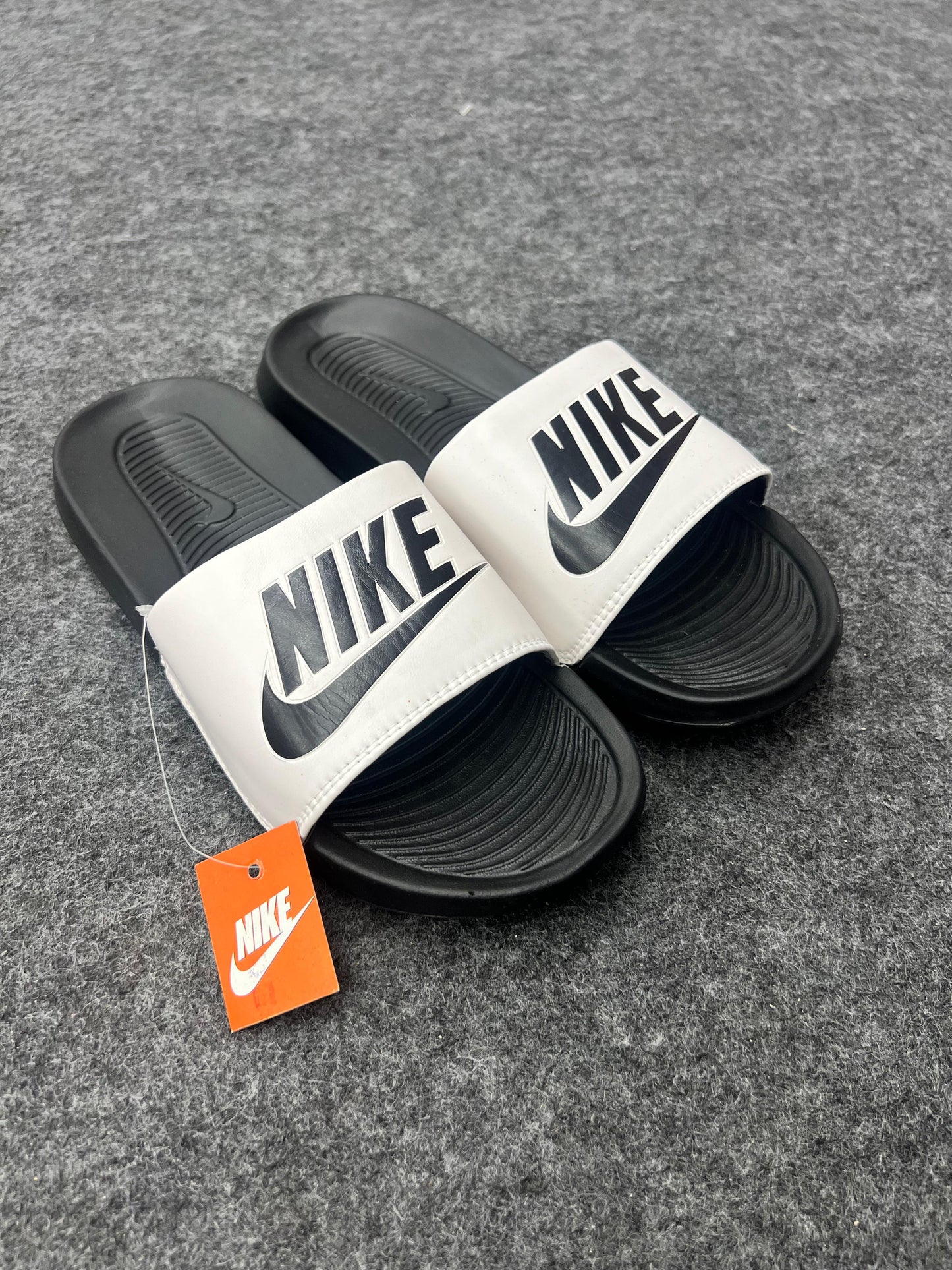 bold black logo on a white strap NIKE SLIDES