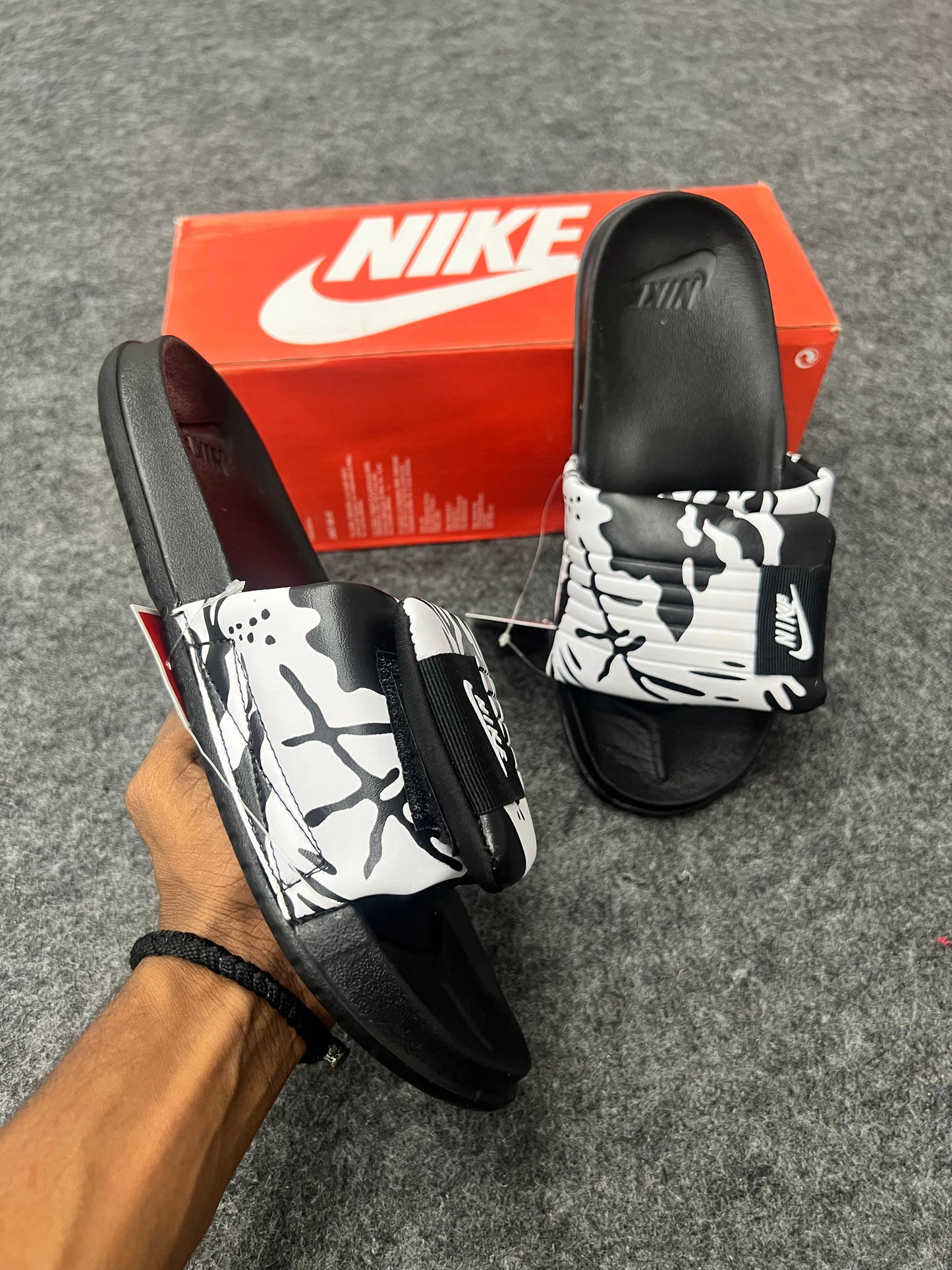 Nike slides with a black & white strap