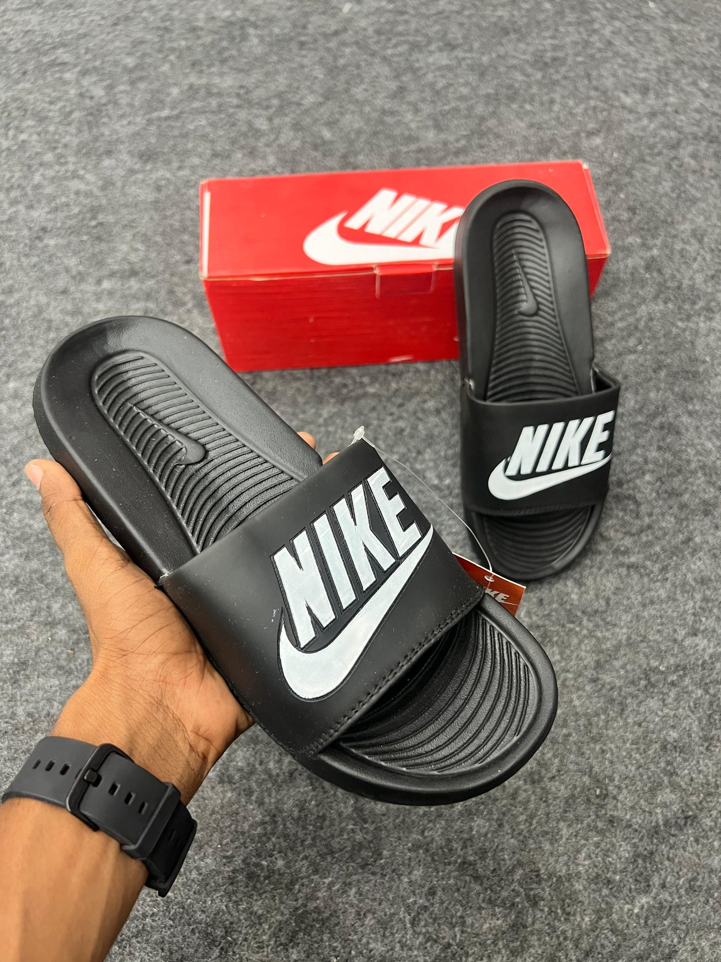 bold white logo for a sharp black Nike slides