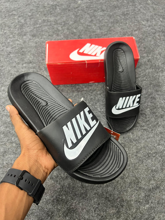 bold white logo for a sharp black Nike slides