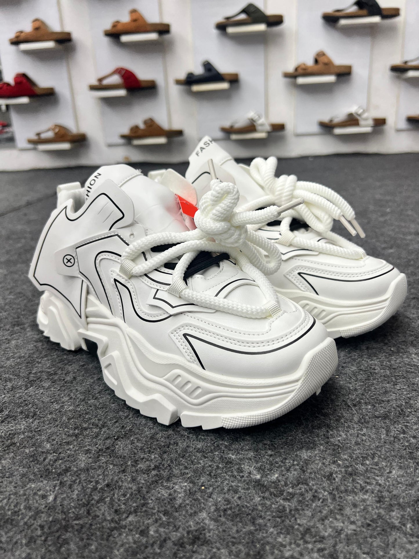 Chunky white sneakers with bold black