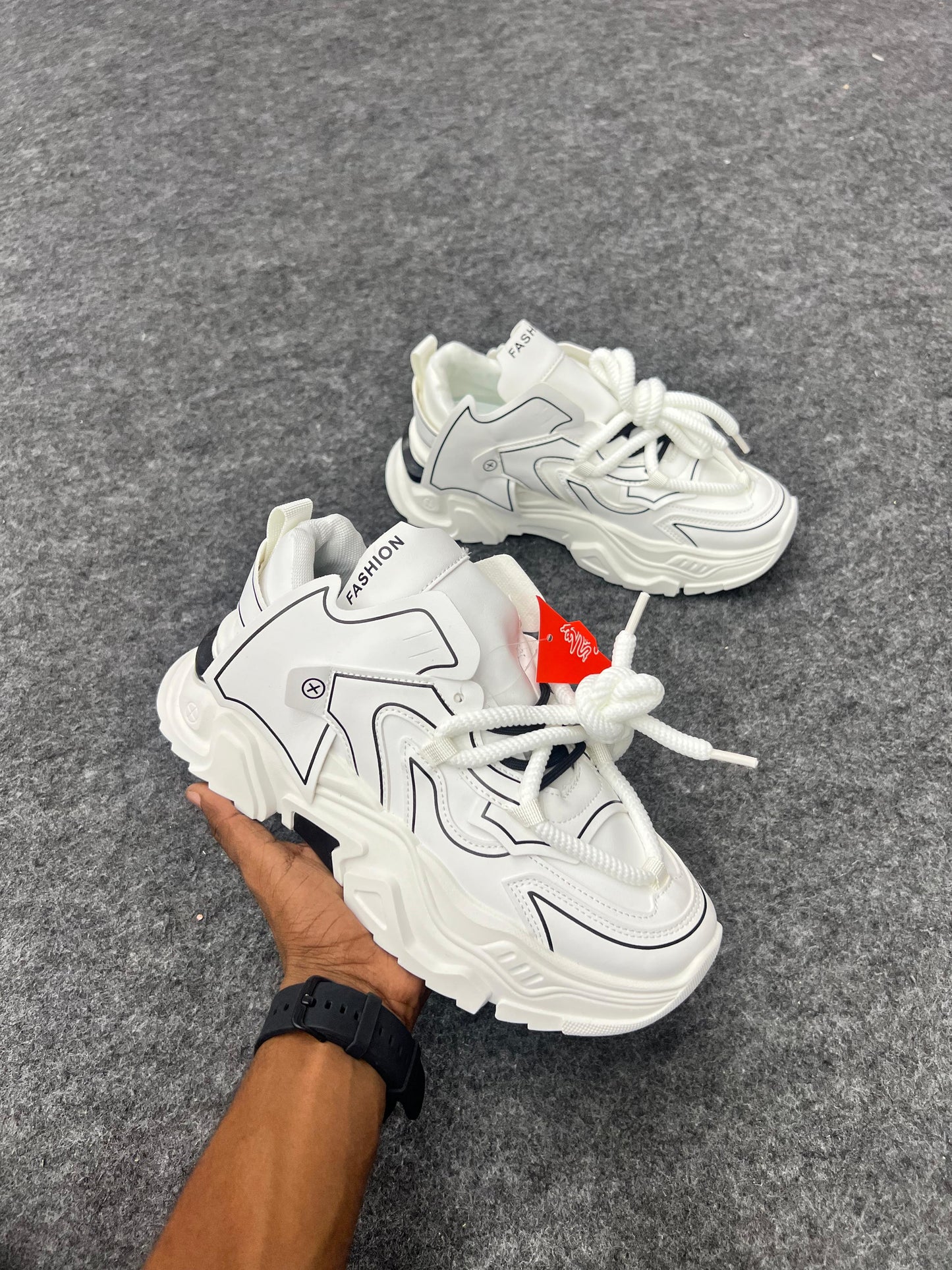 Chunky white sneakers with bold black