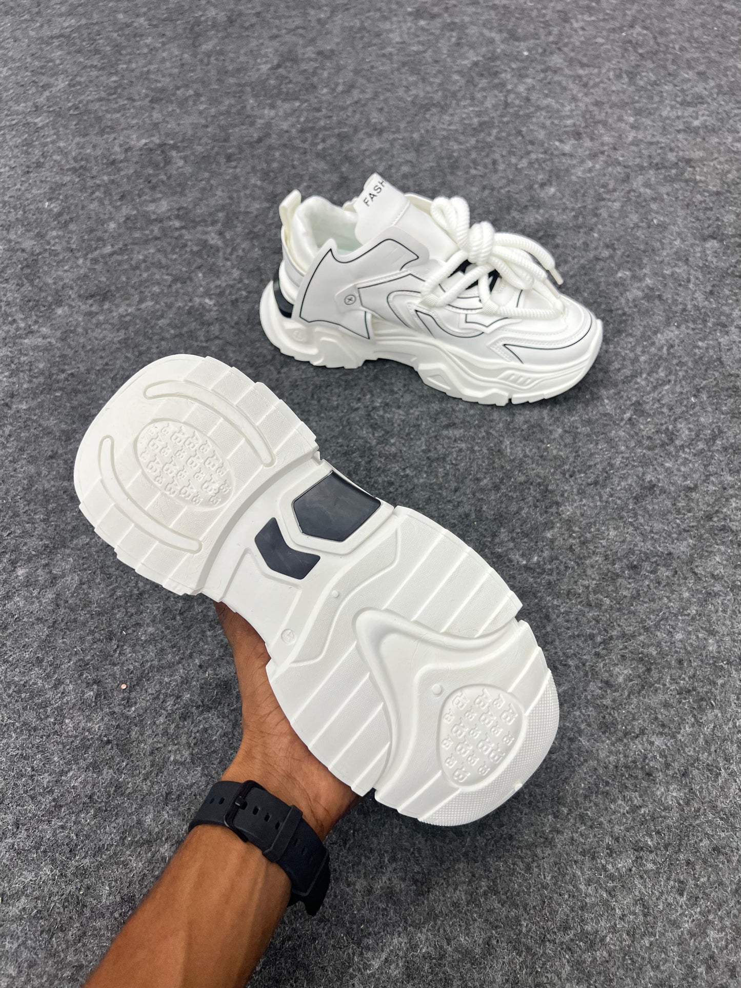 Chunky white sneakers with bold black